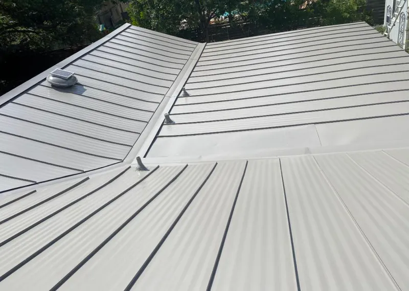 Solar attic fan installed on a metal roof for Roof Ventilation in Woods Creek